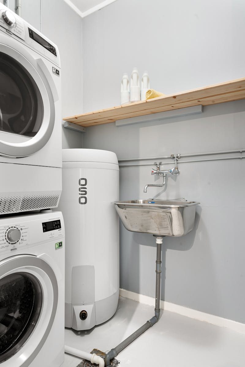 A tidy, organized laundry space with appliances and sink showcasing efficiency and design.